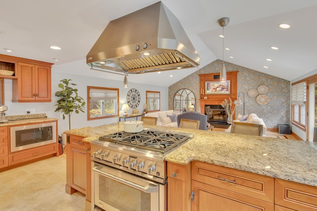 kitchen featuring island exhaust hood, stainless steel range, built in microwave, a fireplace, and hanging light fixtures