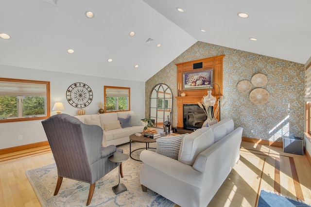 living room featuring light wood-type flooring and vaulted ceiling