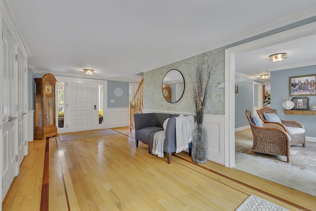 entryway with ornamental molding and hardwood / wood-style flooring