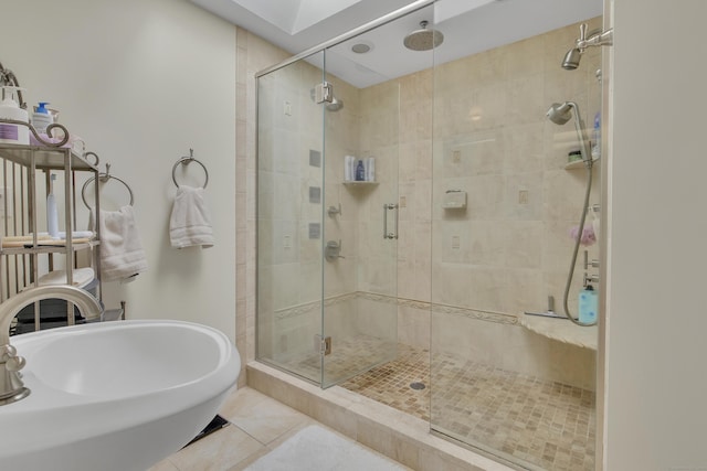 bathroom with tile patterned flooring, a shower with door, and sink