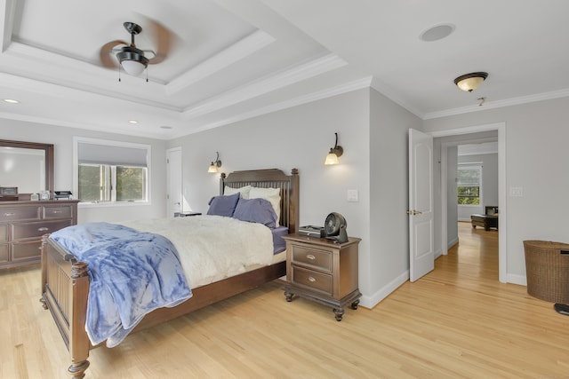 bedroom featuring light wood-type flooring, multiple windows, crown molding, and ceiling fan