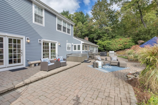 view of patio / terrace featuring an outdoor living space and a hot tub