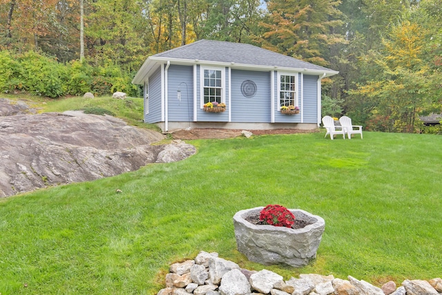 view of outdoor structure with a lawn