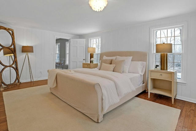 bedroom with wood finished floors and baseboards