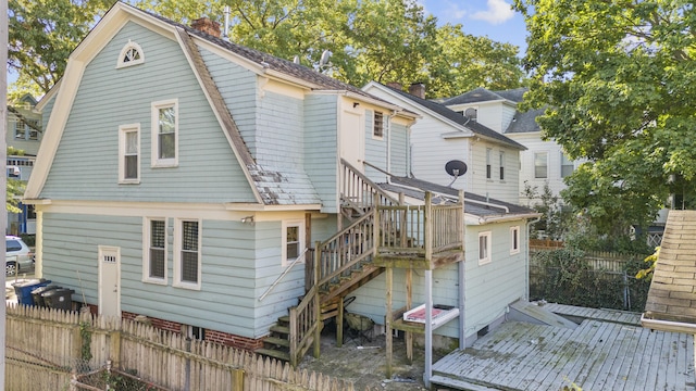 rear view of property featuring a deck