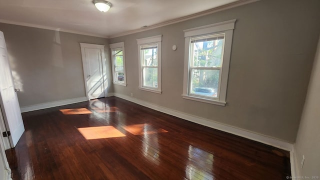 unfurnished room featuring crown molding and dark hardwood / wood-style floors