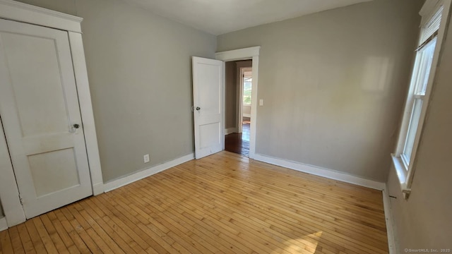 unfurnished bedroom featuring a closet and light hardwood / wood-style flooring