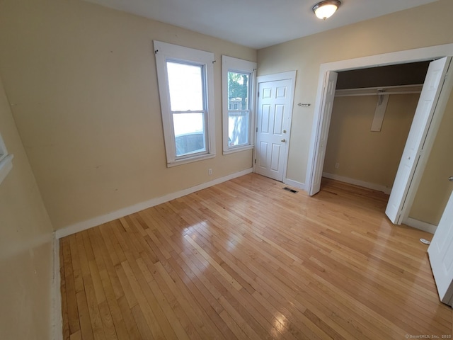 unfurnished bedroom with light wood-type flooring