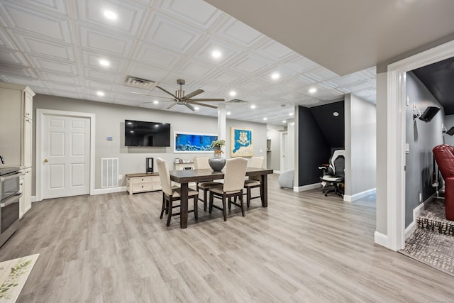 dining area featuring light wood-type flooring and ceiling fan