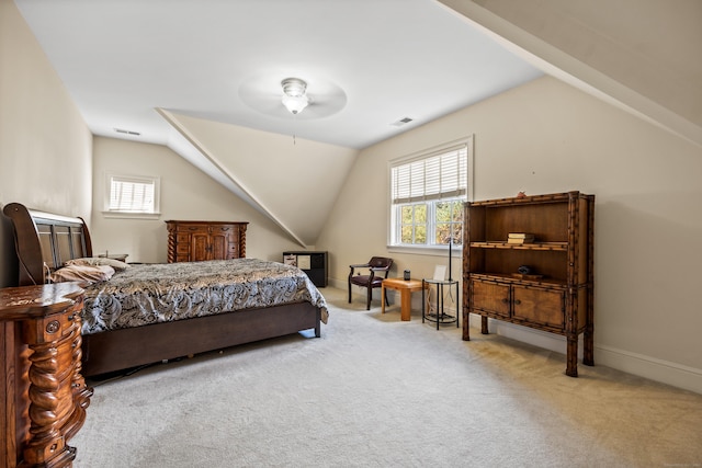 bedroom with vaulted ceiling and light colored carpet