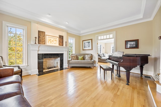 interior space with a fireplace, crown molding, and hardwood / wood-style floors