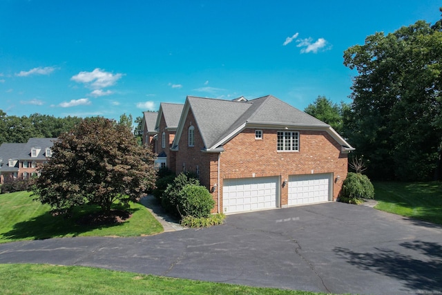 view of property exterior with a garage and a lawn