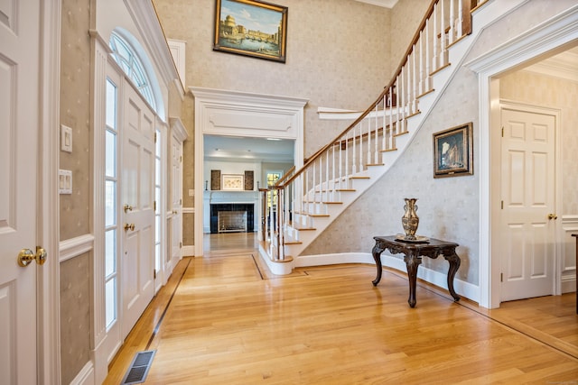 entrance foyer featuring crown molding and hardwood / wood-style floors