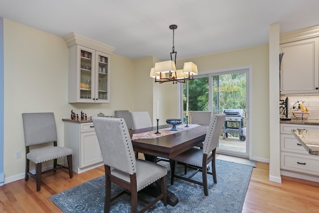 dining room with an inviting chandelier and light hardwood / wood-style floors