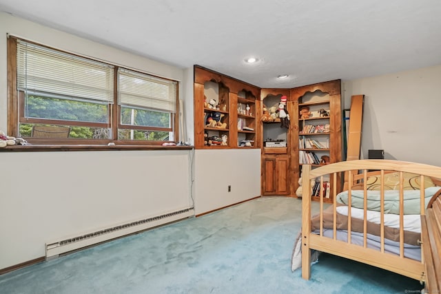 bedroom featuring light carpet and a baseboard heating unit