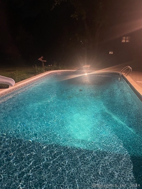 pool at night with a water slide