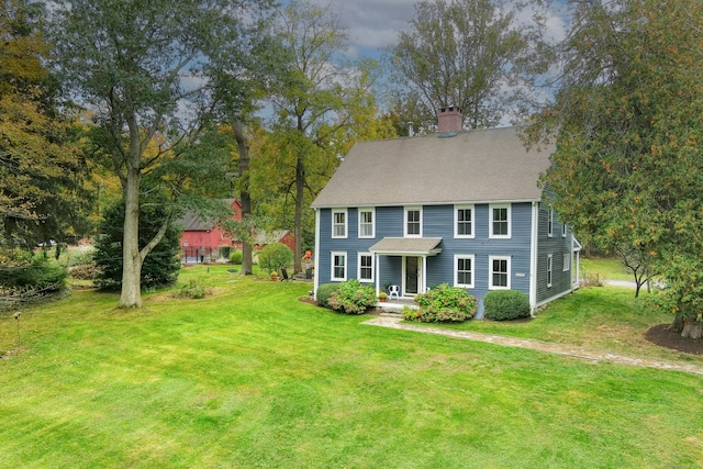 colonial inspired home with a front lawn