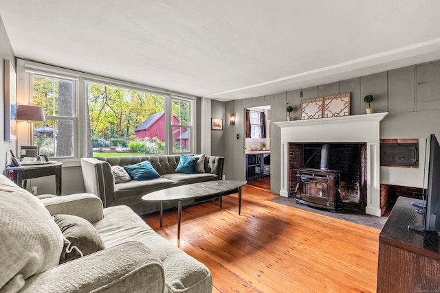 living room with a wood stove and hardwood / wood-style floors