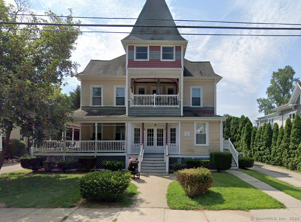 victorian home with a balcony and a porch