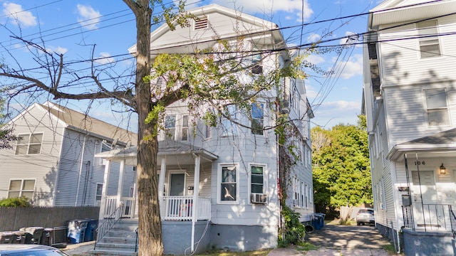 view of property featuring cooling unit and covered porch