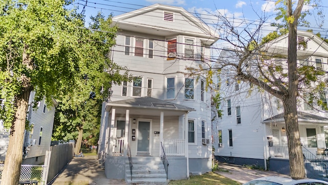 view of front of property featuring cooling unit and a porch