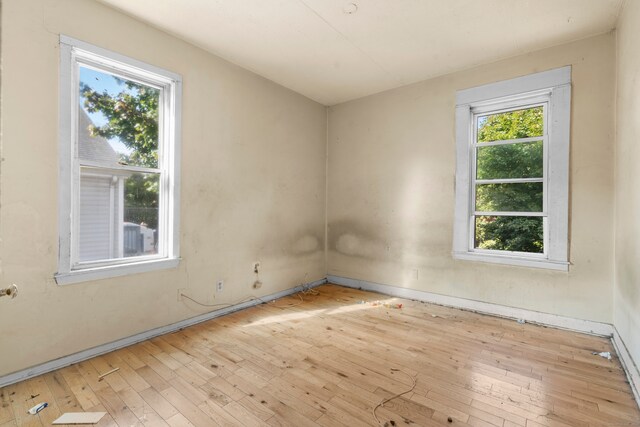 unfurnished room featuring light hardwood / wood-style flooring and plenty of natural light