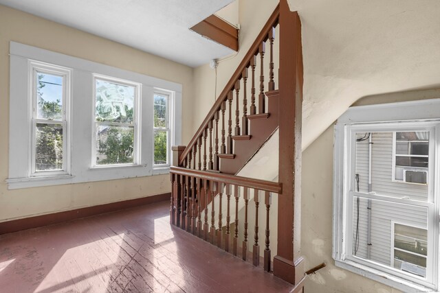 stairway featuring wood-type flooring and vaulted ceiling