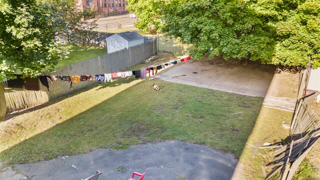 view of yard with a patio and a shed