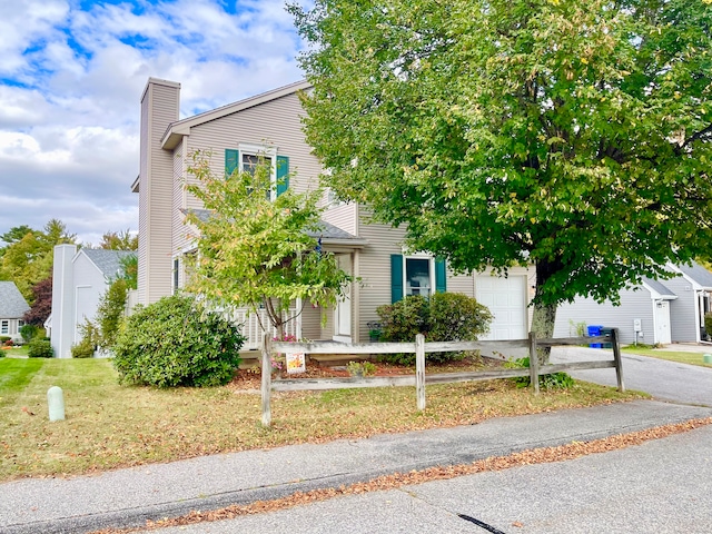 obstructed view of property with a garage