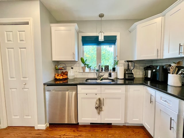 kitchen featuring sink, decorative backsplash, white cabinets, and dishwasher