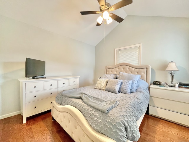 bedroom with hardwood / wood-style flooring, ceiling fan, and vaulted ceiling