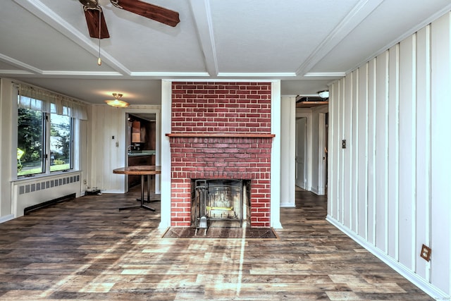 unfurnished living room with radiator, ceiling fan, a fireplace, and hardwood / wood-style floors