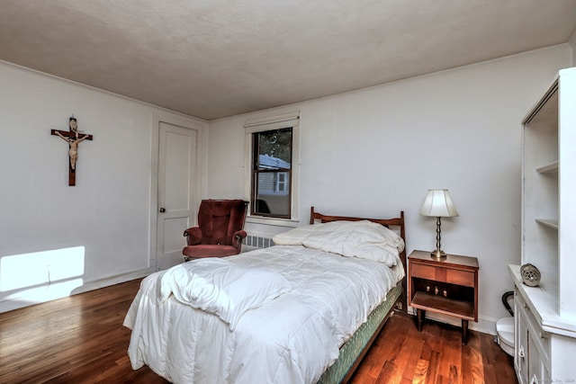 bedroom featuring a textured ceiling, crown molding, and dark hardwood / wood-style flooring