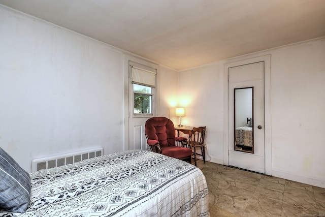 bedroom with crown molding and radiator heating unit