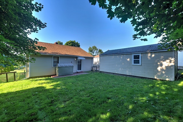 rear view of property featuring a yard