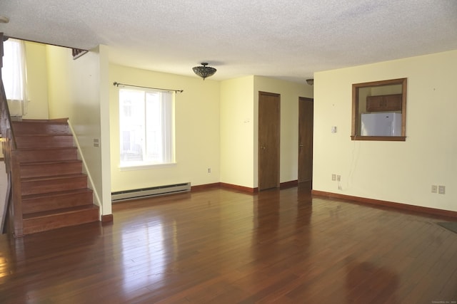 empty room featuring a textured ceiling, dark hardwood / wood-style floors, and baseboard heating