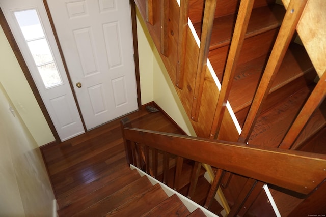 stairs featuring hardwood / wood-style floors