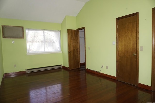 unfurnished room featuring vaulted ceiling, dark hardwood / wood-style flooring, and a baseboard heating unit