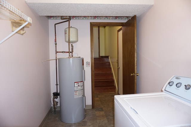 laundry area with washer / dryer, electric water heater, and a textured ceiling