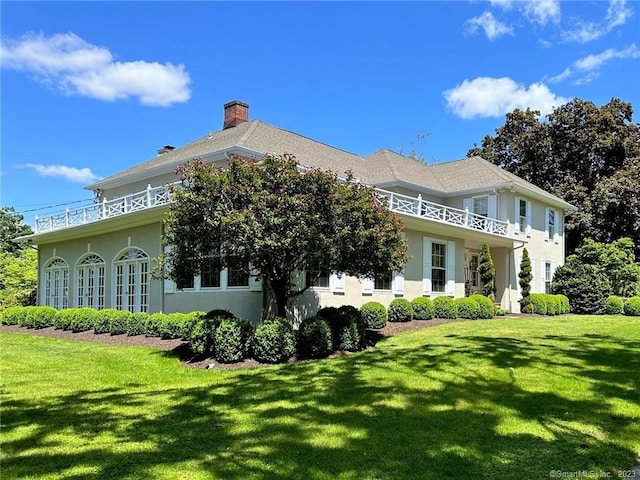 rear view of property featuring a yard