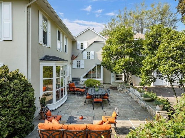 back of house with a patio and an outdoor living space