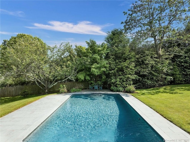 view of pool featuring a yard