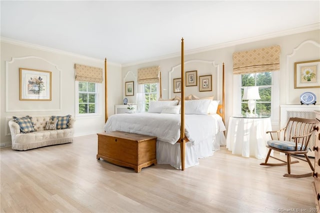 bedroom with ornamental molding and light wood-type flooring