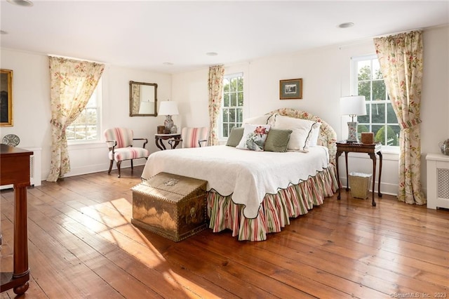 bedroom featuring wood-type flooring and radiator heating unit