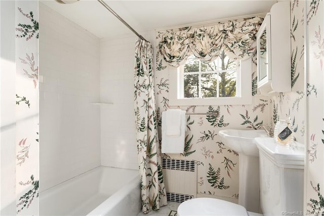 bathroom with shower / bath combo with shower curtain, radiator heating unit, and toilet