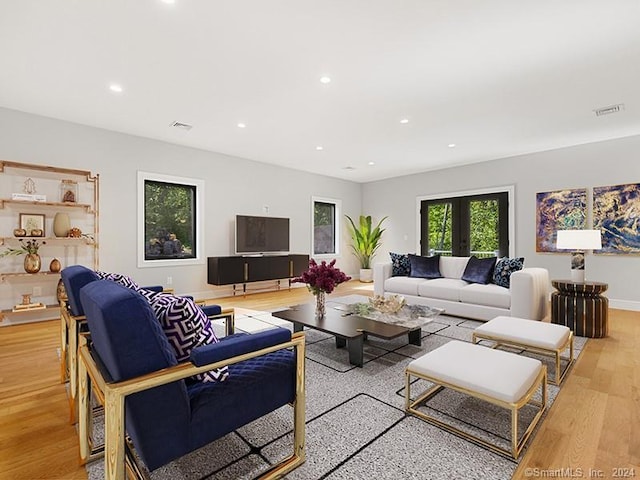 living room with french doors and light hardwood / wood-style floors