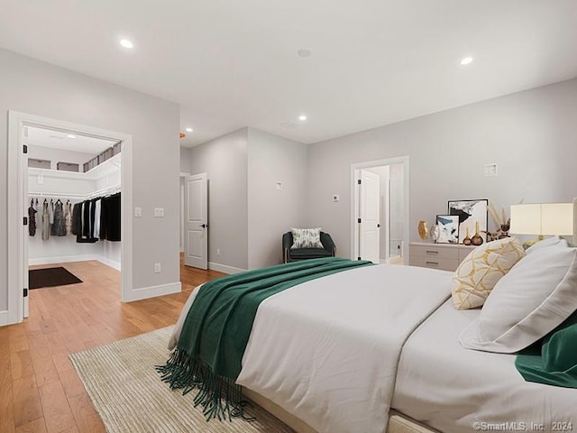 bedroom featuring light wood-type flooring and a closet