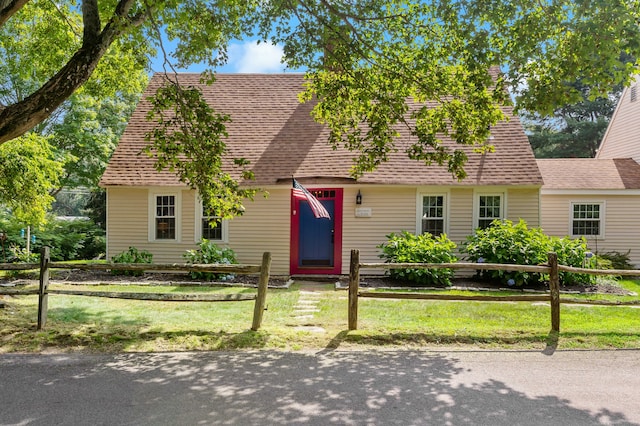 cape cod house with a front lawn