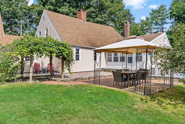 back of house featuring a patio and a lawn