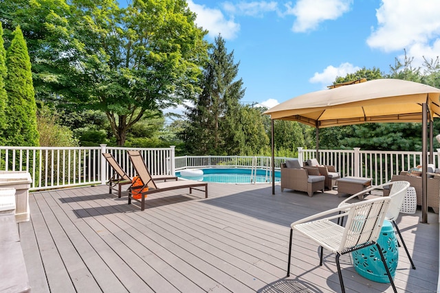 deck with a fenced in pool and a gazebo